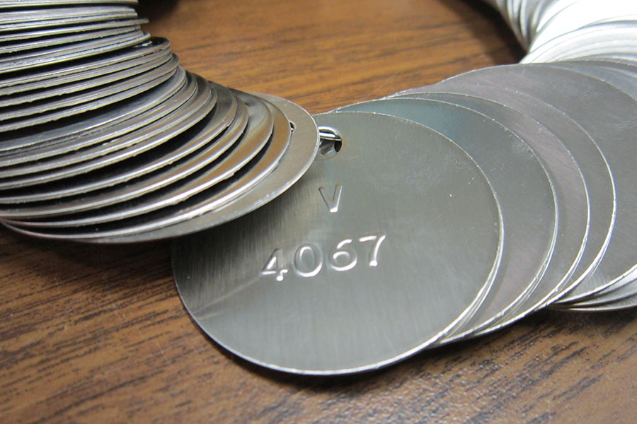 Protouch Engraving Ltd. Our Services. Industrial Engraving Signage 2025 Embossing. A set of circular embossed tags.