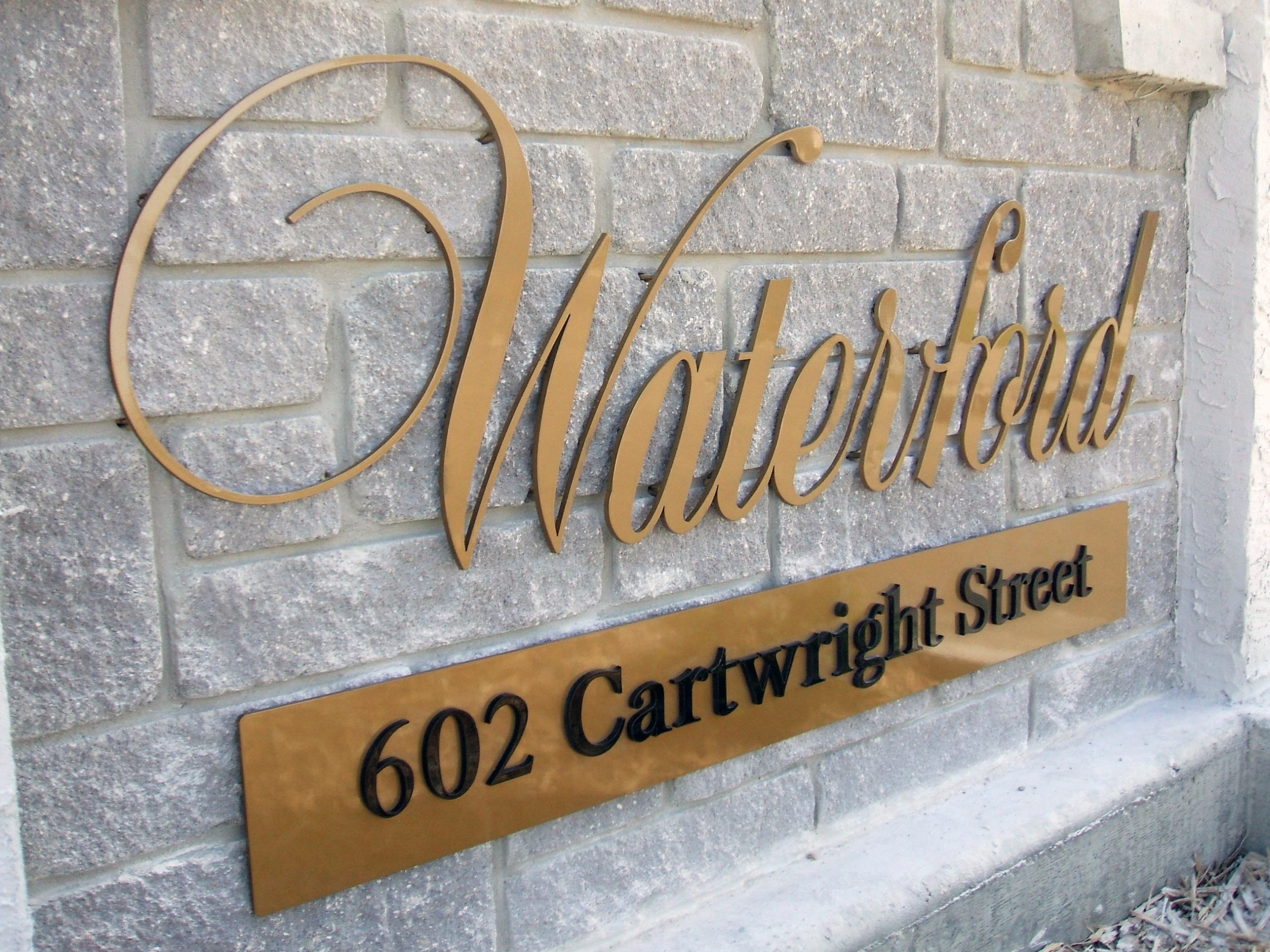 Protouch Engraving Ltd. Industrial Engraving Signage 2025 Signage. A pin mounted logo set into a brick wall.